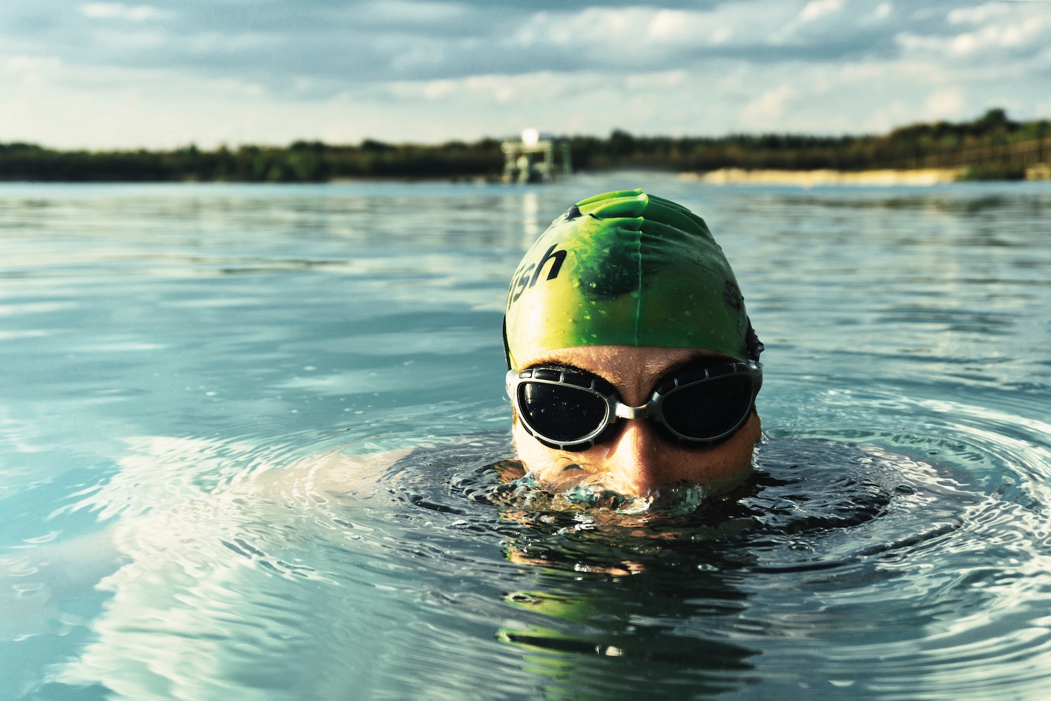 Swimmer wearing SolRX Waterblock water resistant sunscreen, independently tested through 8 hours of water exposure