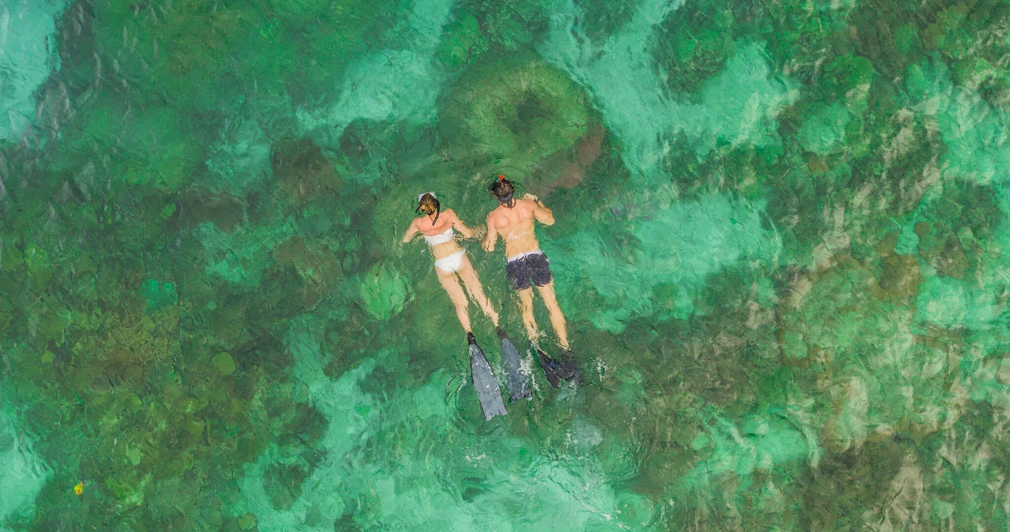 Swimmers in open water wearing SolRX Waterblock sunscreen, the longest lasting water resistant formula tested at 8 hours