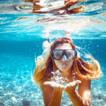 Woman snorkeling underwater SolRX Waterblock sunscreen clinically tested water resistance